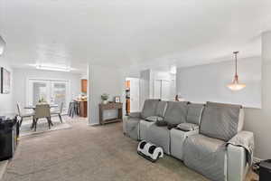 Living room with light colored carpet and french doors