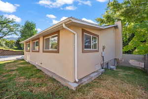 View of side of property with stucco siding and a chimney