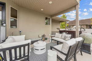 View of patio featuring an outdoor hangout area and a hot tub