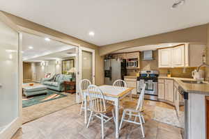 Dining area with recessed lighting and light carpet
