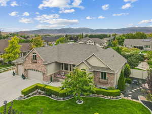 View of front of property with an attached garage, a residential view, stucco siding, driveway, and a shingled roof