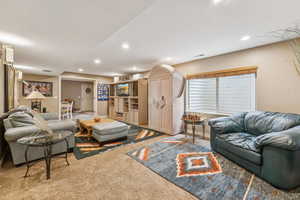 Carpeted living area featuring recessed lighting