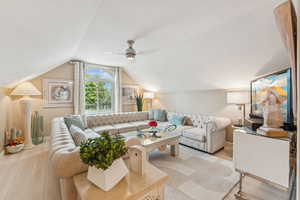 Living room with light wood-style flooring and lofted ceiling