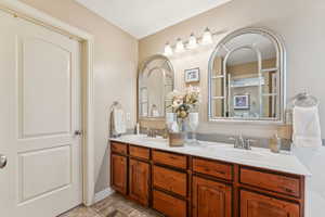 Bathroom featuring double vanity and light tile patterned floors