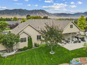Rear view of property featuring outdoor lounge area, stucco siding, a patio area, and a mountain view