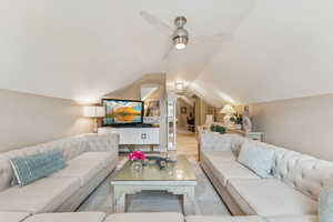 Living room with vaulted ceiling and ceiling fan