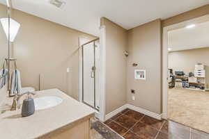 Bathroom with a stall shower and vanity and Laundry Hookups