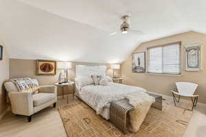 Bedroom featuring lofted ceiling, light wood-style flooring, and ceiling fan