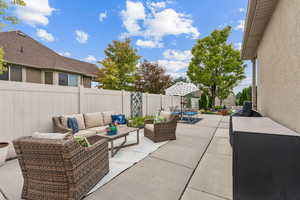 Fenced backyard featuring a patio and an outdoor hangout area