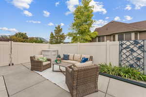 Fenced backyard featuring an outdoor hangout area and a patio area
