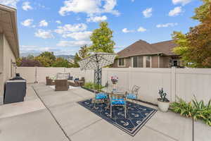 Fenced backyard featuring a patio, an outdoor hangout area, and outdoor dining space