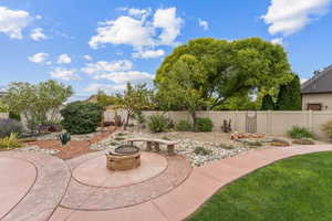 Fenced backyard featuring a patio and an outdoor fire pit