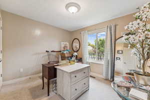 Office featuring light carpet and baseboards