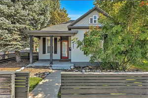 View of front of house featuring a porch and stucco siding