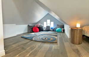 Bonus room featuring wood finished floors and lofted ceiling