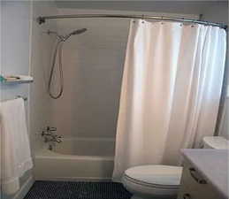 Full bath with vanity, shower / tub combo, and tile patterned floors