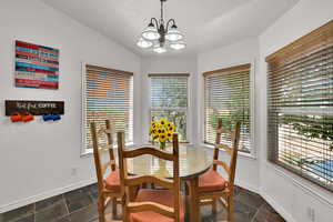 Dining area featuring vaulted ceiling.
