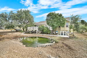 Rear view of property featuring stairs, a patio area, and a wooden deck