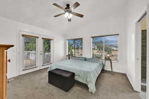 Bedroom featuring access to outside, lofted ceiling, carpet flooring, and ceiling fan