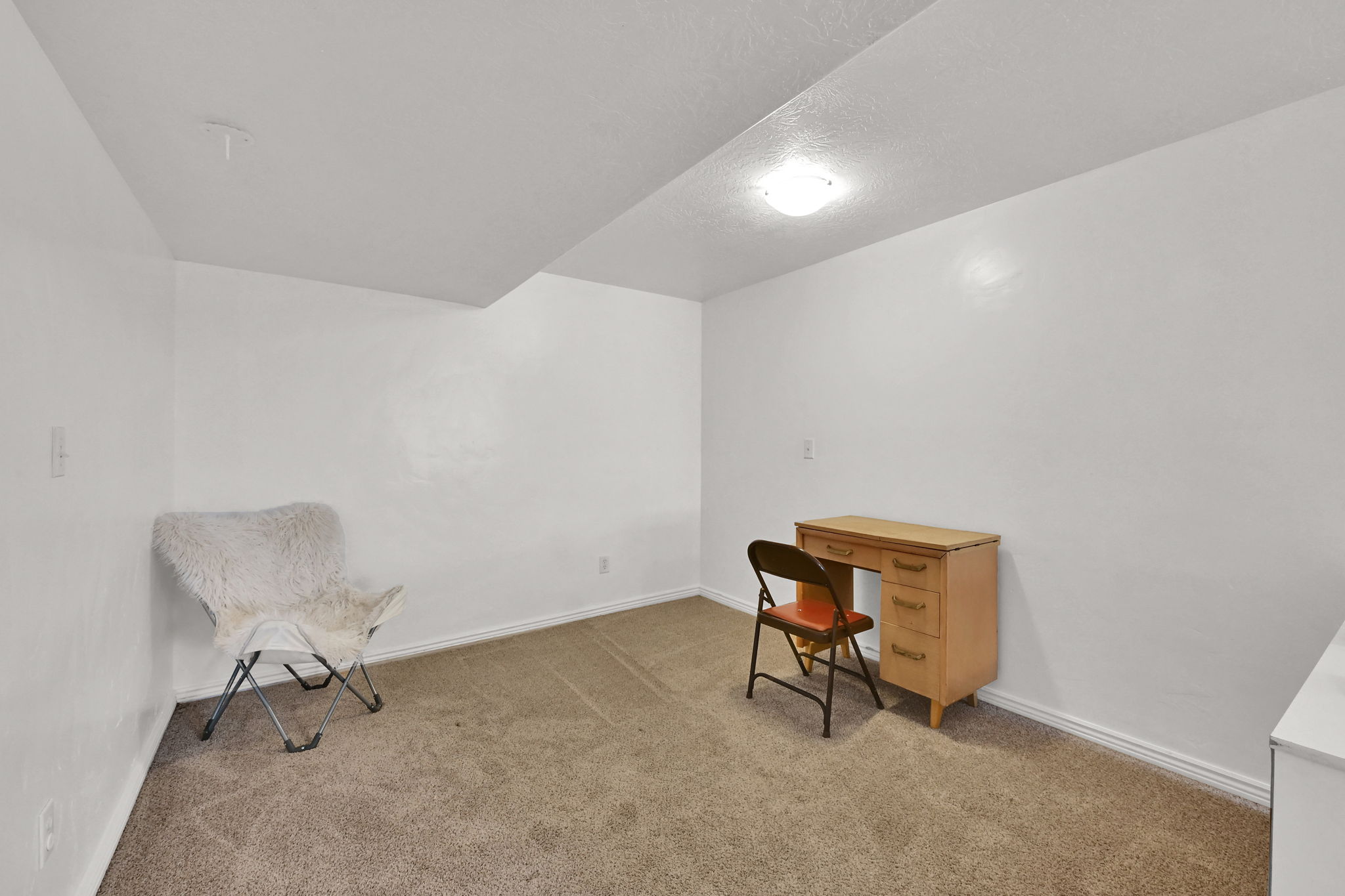 featuring carpet flooring and a textured ceiling