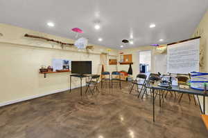 Rec room featuring concrete flooring and recessed lighting