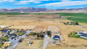Aerial overview of property's location with a mountain backdrop and rural landscape