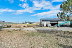 View of yard with an outdoor structure, an outbuilding, and a garage