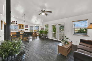 Living room featuring wood finished tile, lofted ceiling, and ceiling fan