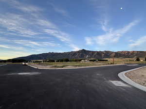 View of asphalt street with a mountain view and curbs