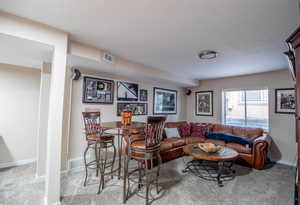 Living room featuring light colored carpet and baseboards
