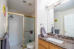 Bathroom with a stall shower and vanity