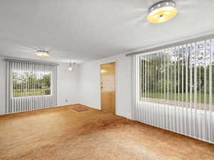 Spare room featuring a textured ceiling and carpet flooring
