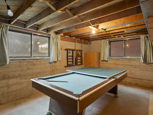 Game room with finished concrete flooring and billiards