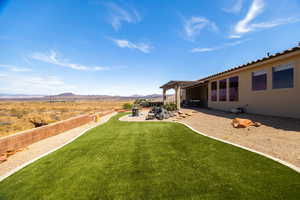 View of yard featuring a pergola, a patio, and a mountain view