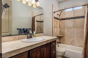 Full bath with shower / bath combination with curtain and vanity
