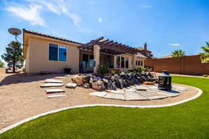 Rear view of house featuring a patio, a pergola, stucco siding, and a tiled roof