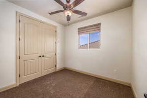 Bedroom with carpet, a closet, and ceiling fan
