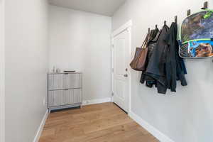 Hall with hardwood / wood-style floors and baseboards
