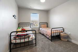 Carpeted bedroom featuring baseboards