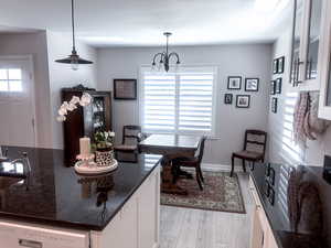 Dining area featuring a chandelier and light laminate floors