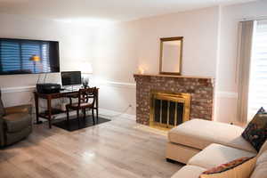 Family Room with laminate floor and a brick fireplace!