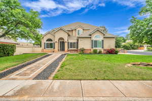 Traditional home featuring stucco siding and a tile roof