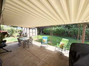 View of patio / terrace with a storage unit and outdoor dining area