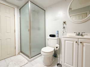 Bathroom featuring vanity, a stall shower, and tile patterned flooring