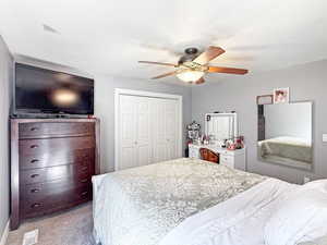 Bedroom featuring light carpet, a closet, and ceiling fan