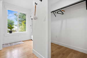 Spacious closet with light wood-style floors