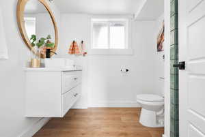 Bathroom featuring vanity, light wood-type flooring, and a textured ceiling