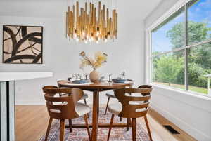 Dining area with a chandelier and wood finished floors