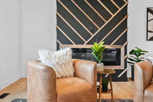 Sitting room featuring light wood finished floors and baseboards