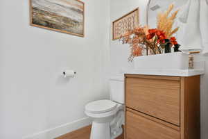 Bathroom with baseboards and light wood-style flooring